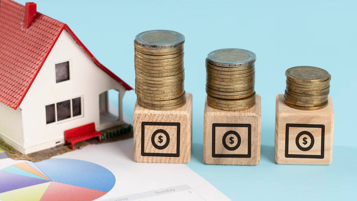 Model house beside stacks of coins on wooden blocks, symbolizing real estate investment and financial growth, with a pie chart in the foreground.